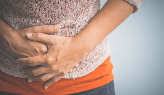 photo of woman's hands over her stomach