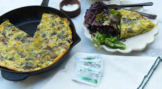 christmas frittata in skillet and on plate with salad and packets of lypo-spheric r-alpha lipoic acid